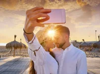 pngtree-couple-young-selfie-photo-in-beach-together-vacation-sunrise-at-spain-image_1592195.webp